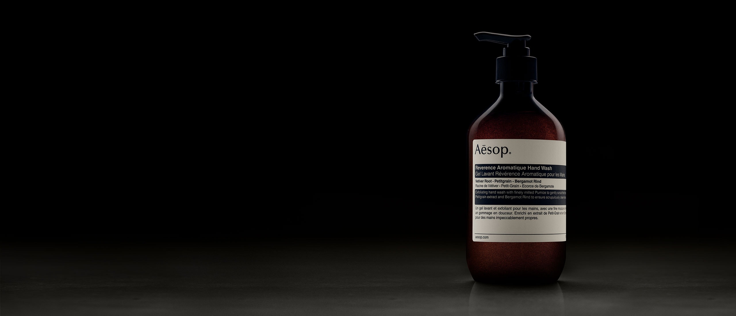 Reverence Aromatique Hand Wash bottle placed in front of dark background
