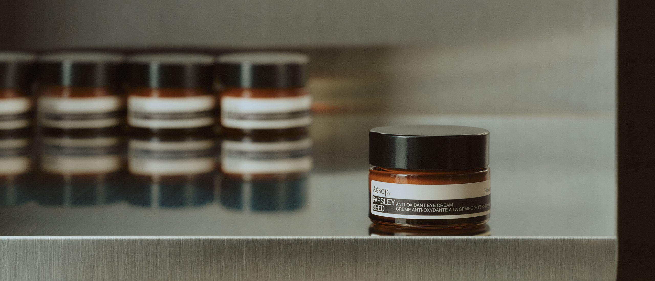 Parsley Seed Anti-Oxidant Eye Cream jars placed on a metal surface